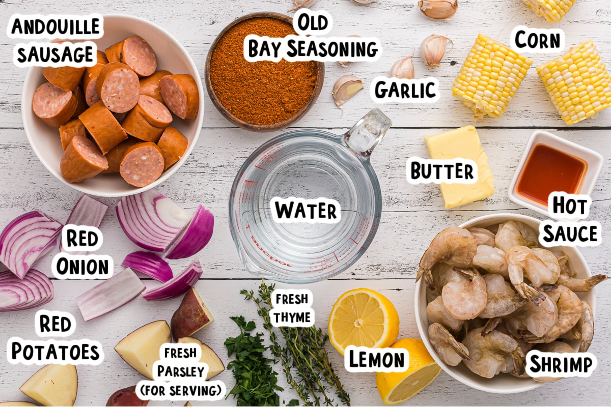 Ingredients for a shrimp boil on table with text overlay.