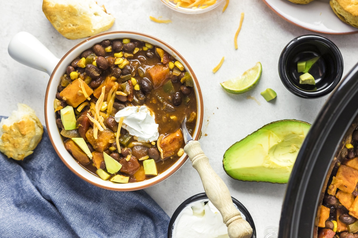 over head shot of sweet potato chili in bowl with sour cream.