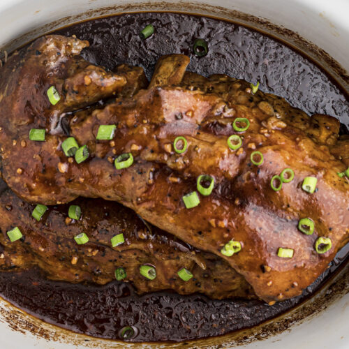 close up of teriyaki ribs with green onion on top