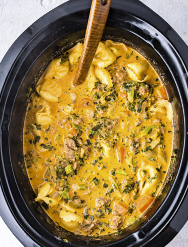 close up of tortellini soup done cooking in crockpot