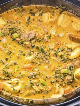 close up of tortellini soup in slow cooker