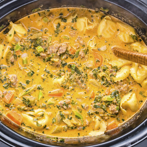 close up of tortellini soup in slow cooker