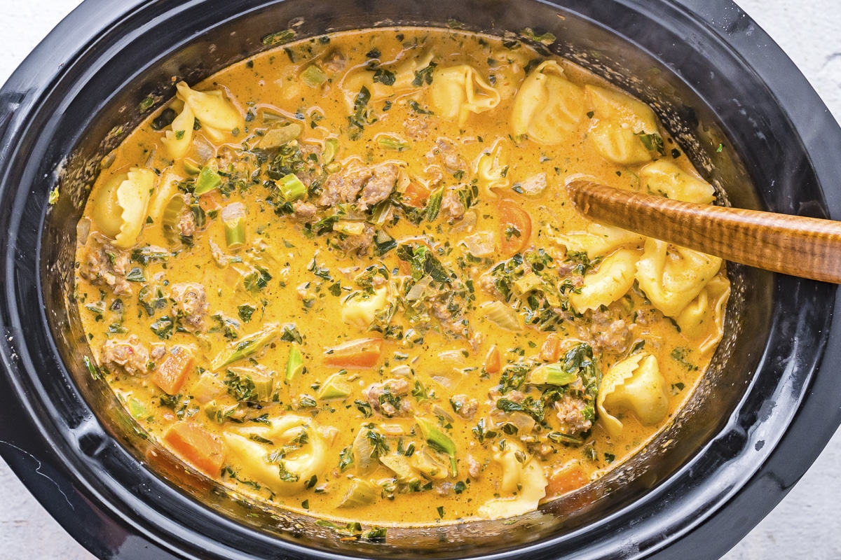 close up of tortellini soup in slow cooker