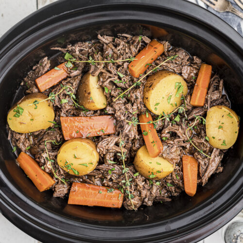 venison pot roast shredded with vegetables in crockpot