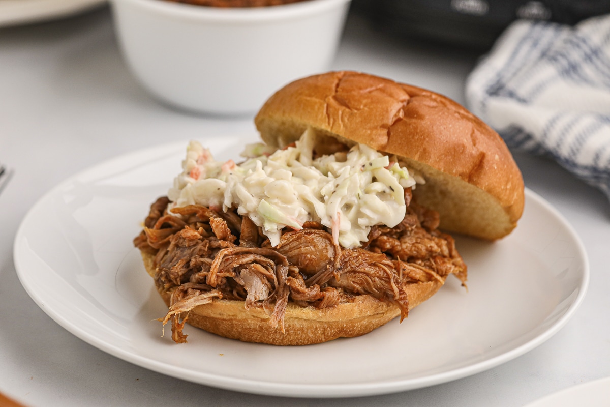 close up of beer pulled pork sandwich with coleslaw.