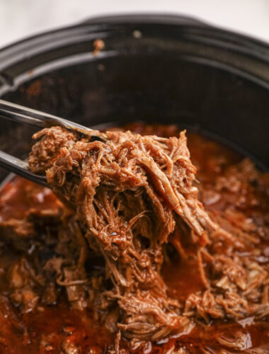 beer pulled pork, shredded on tongs.