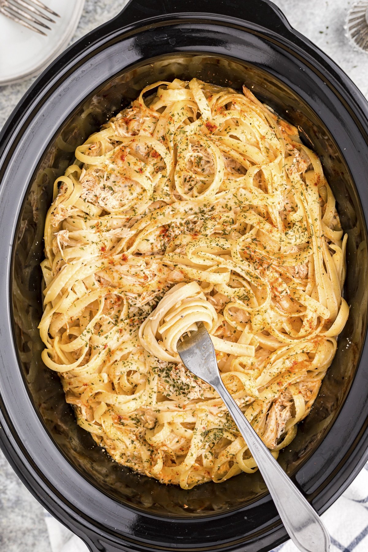 Close up of cajun chicken fettuccine in slow cooker.