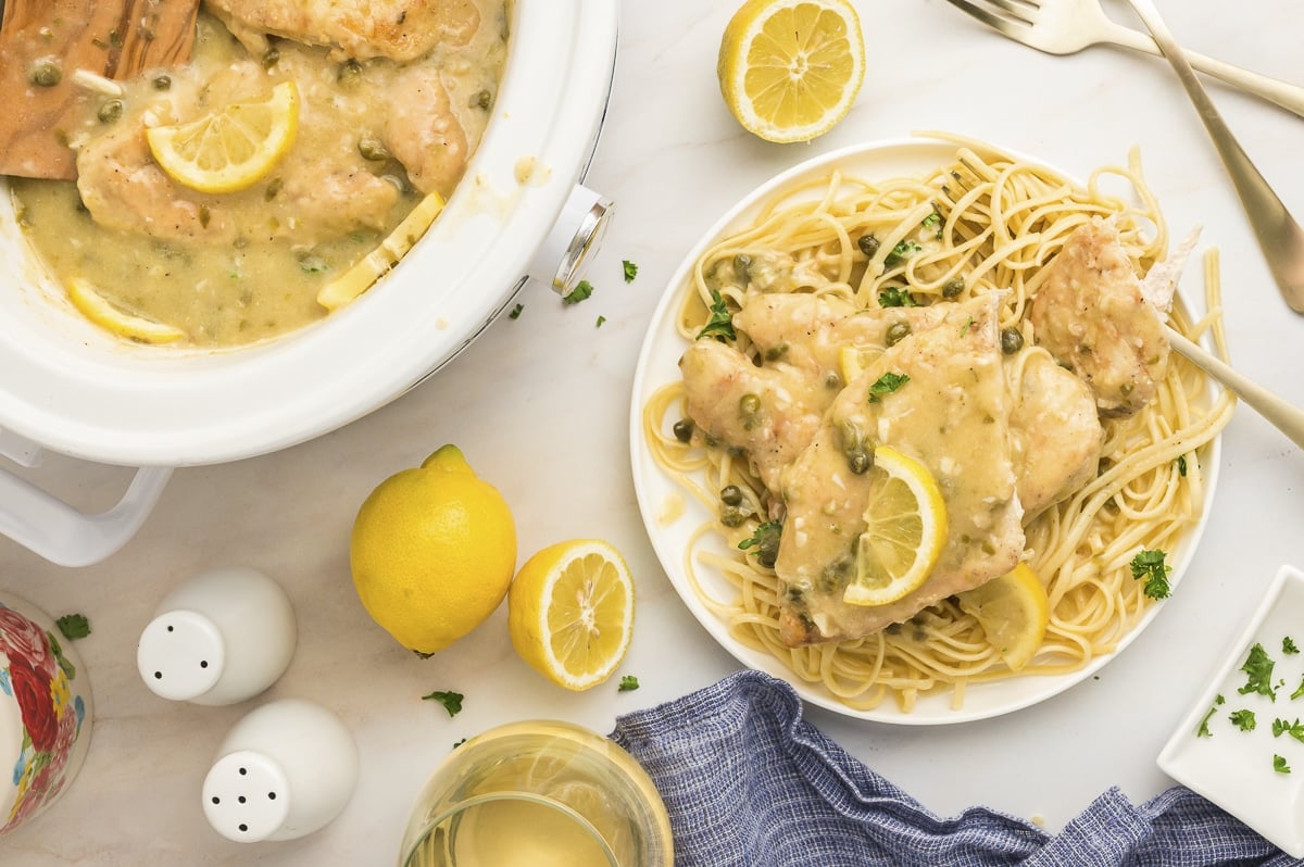 overhead shot of chicken piccata on pasta.