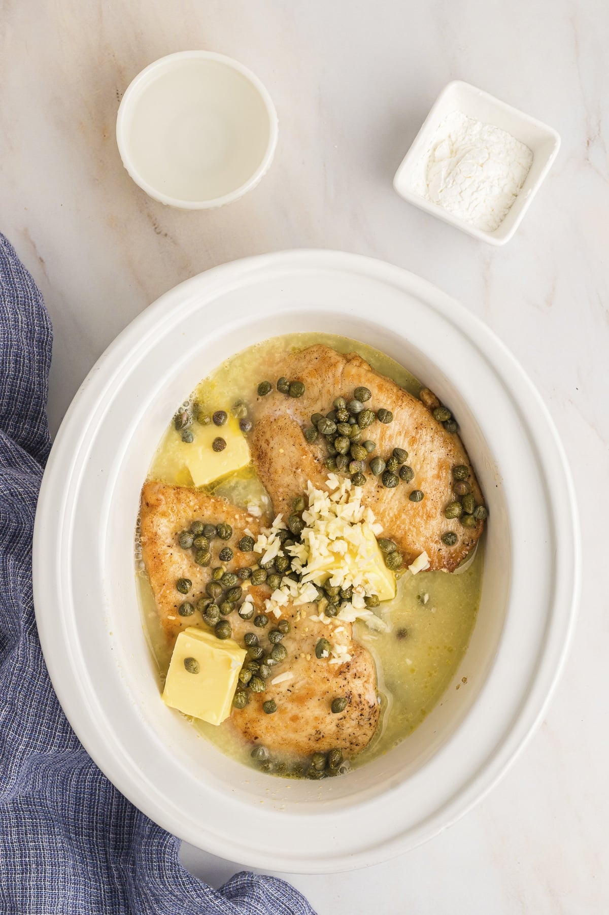 chicken piccata before cooking in a slow cooker.