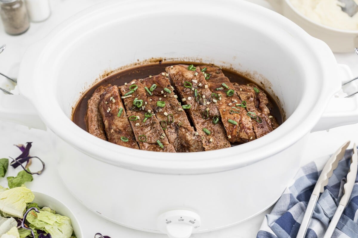 dr. pepper ribs in white slow cooker.