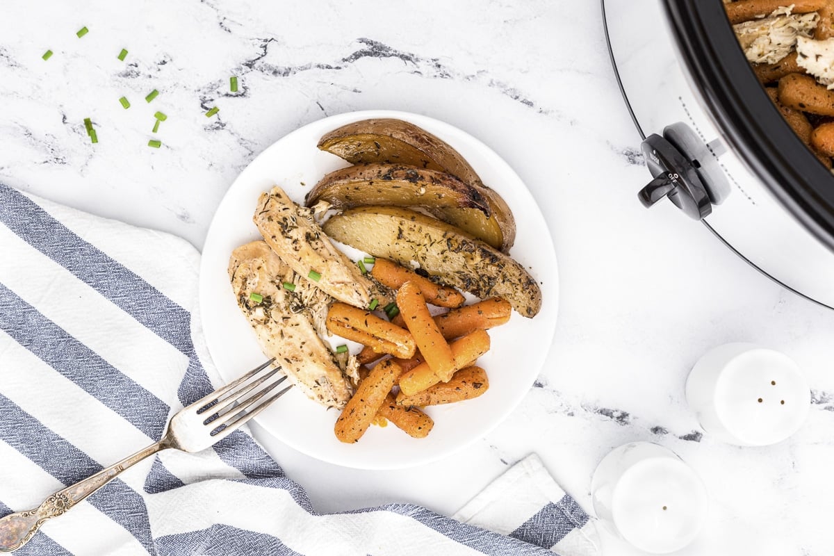 over head shot of plate of chicken, potatoes and vegetables.