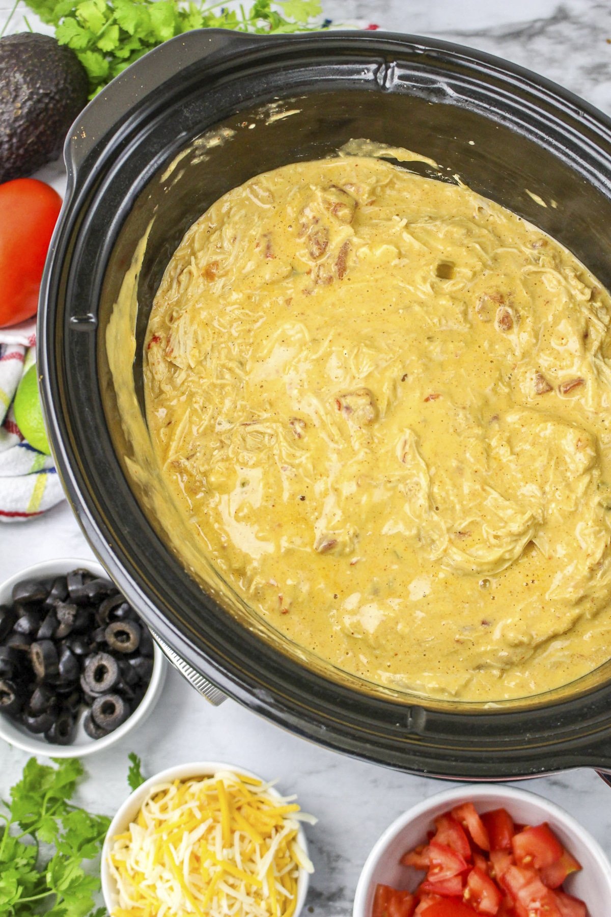 chicken in queso sauce in crockpot.