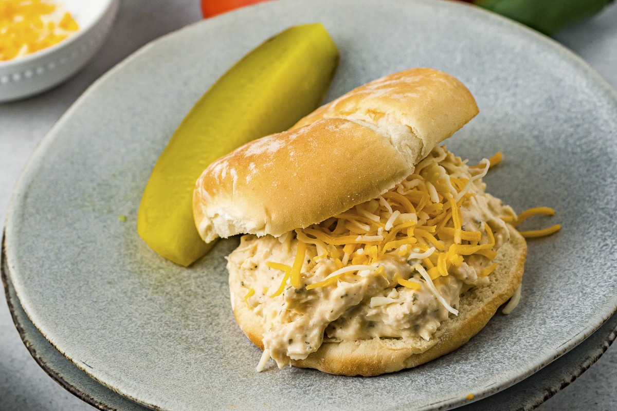 close up of a ranch chicken sandwich with a pickle.