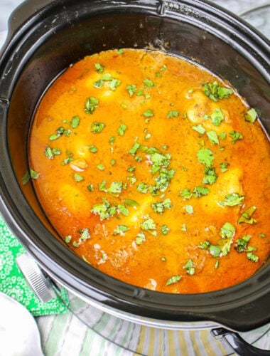 Thai peanut chicken in slow cooker with cilantro on top.