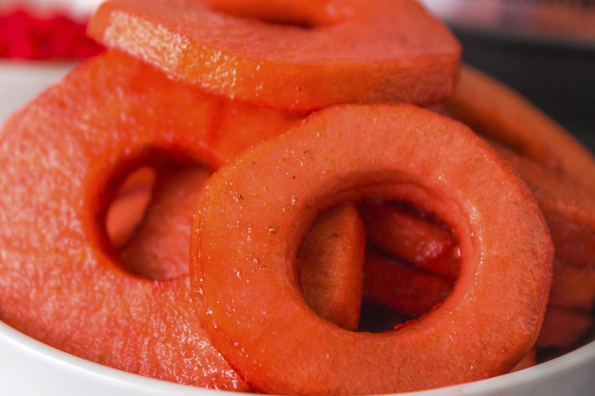 very close up shot of red hot apples in a bowl.