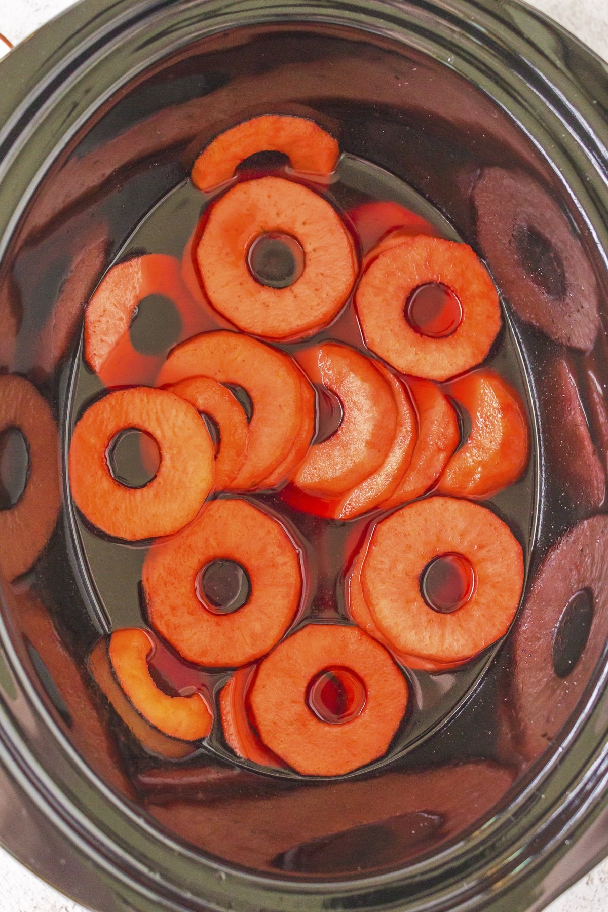 Red hot apples cooked in a slow cooker.