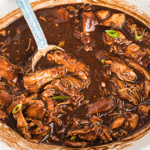 Cooked chicken in bourbon sauce in slow cooker.