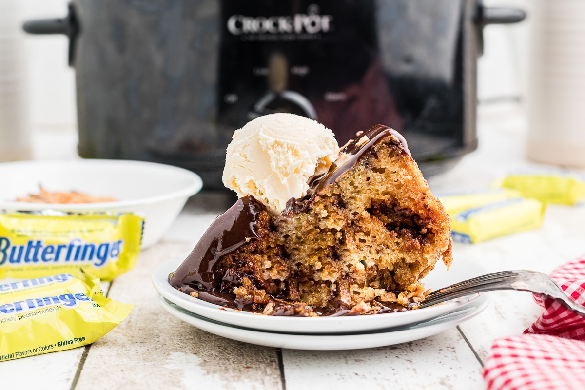slice of butterfinger cake with ice cream on top.
