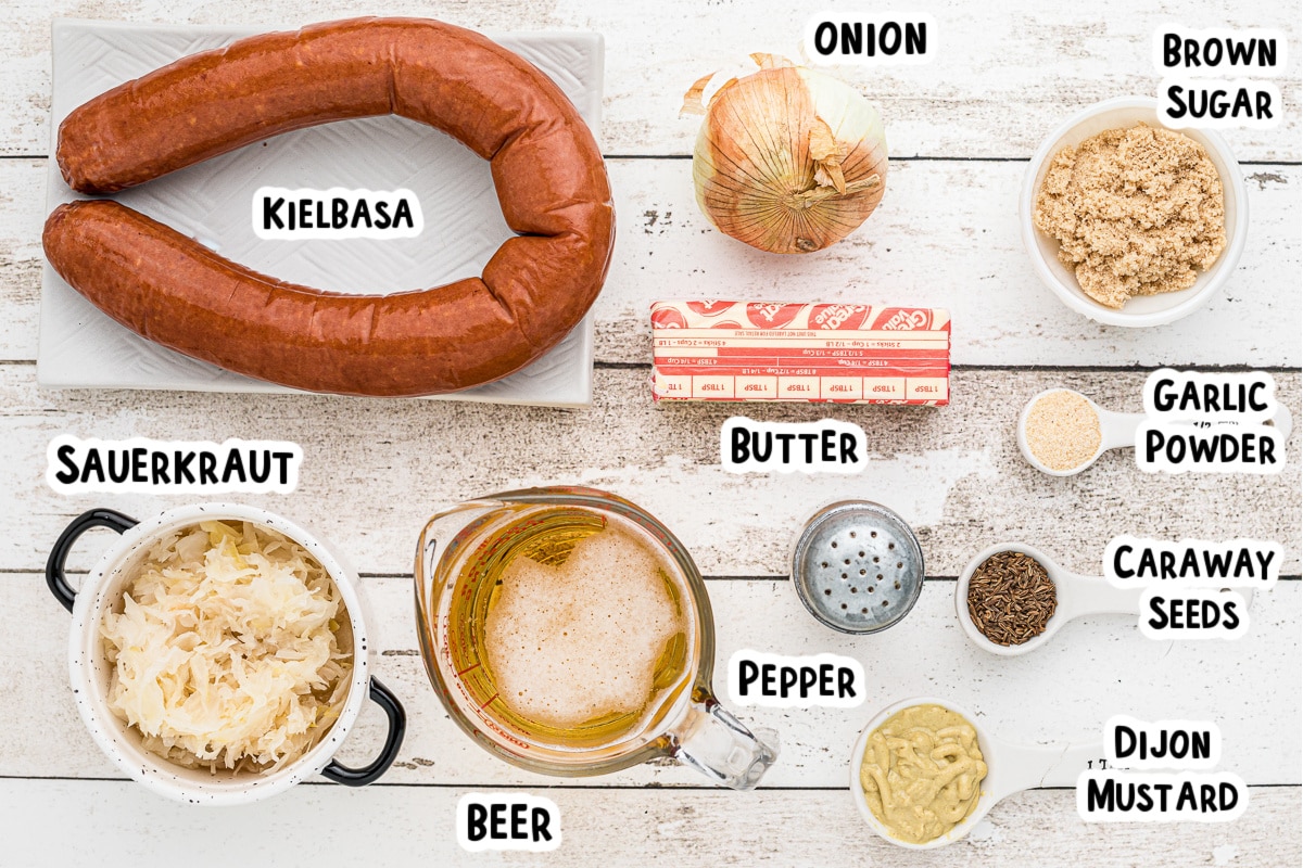 Ingredients for kielbasa and sauerkraut on table.