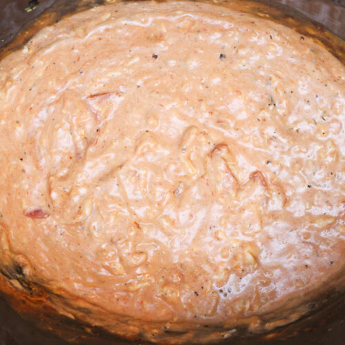 close up of pizza dip in slow cooker.