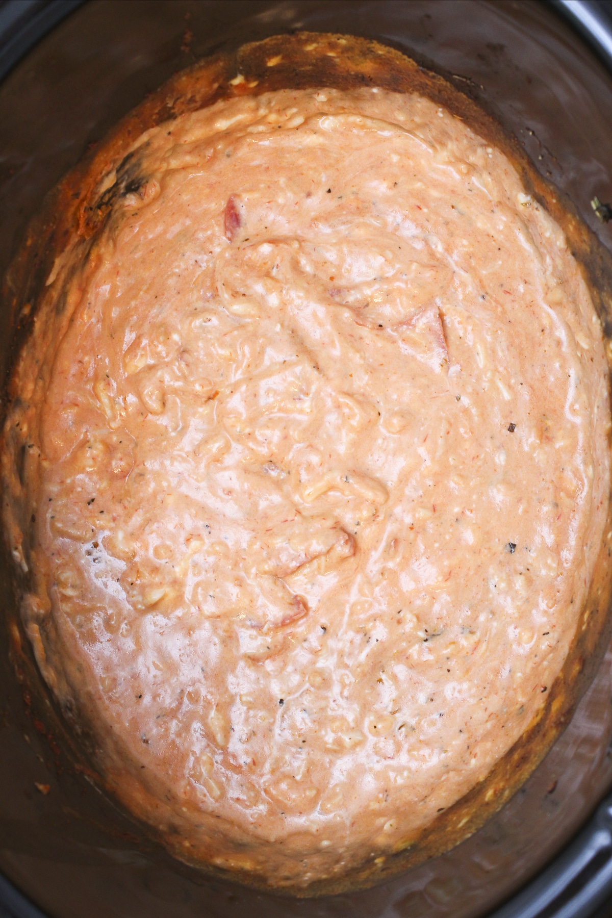 close up of pizza dip done cooking in slow cooker.