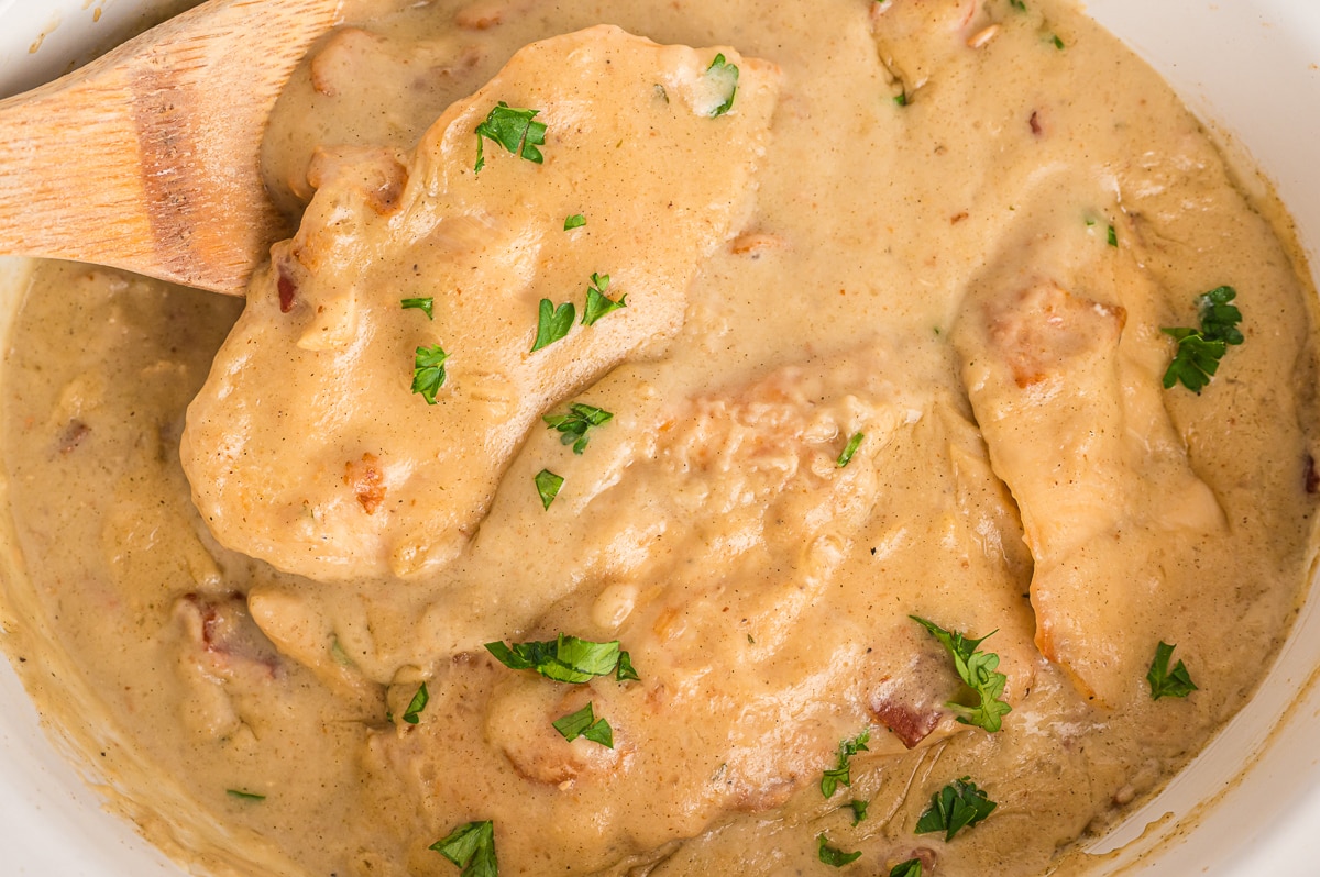 close up of smothered chicken in slow cooker.