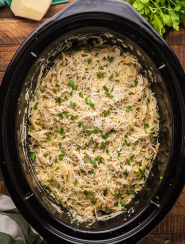 overheard shot of angel chicken and pasta in crockpot.