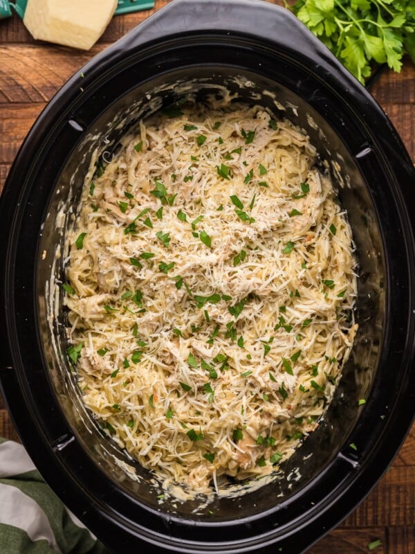 overheard shot of angel chicken and pasta in crockpot.