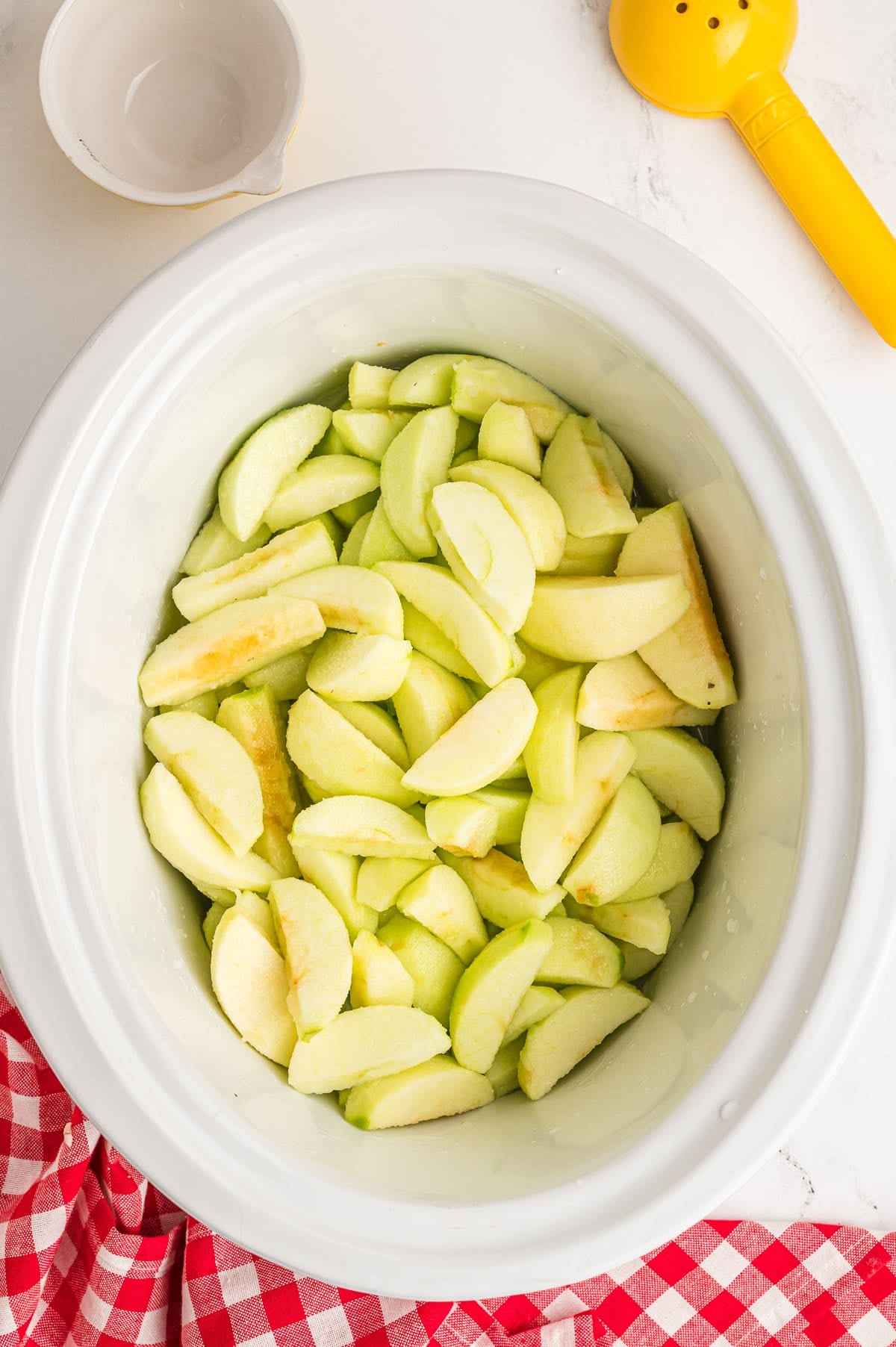 Apples in a crockpot ready to be made in to applesauce.