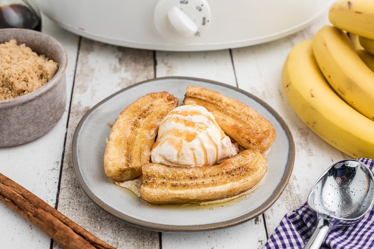 plate with ice cream and three slices of banana foster.