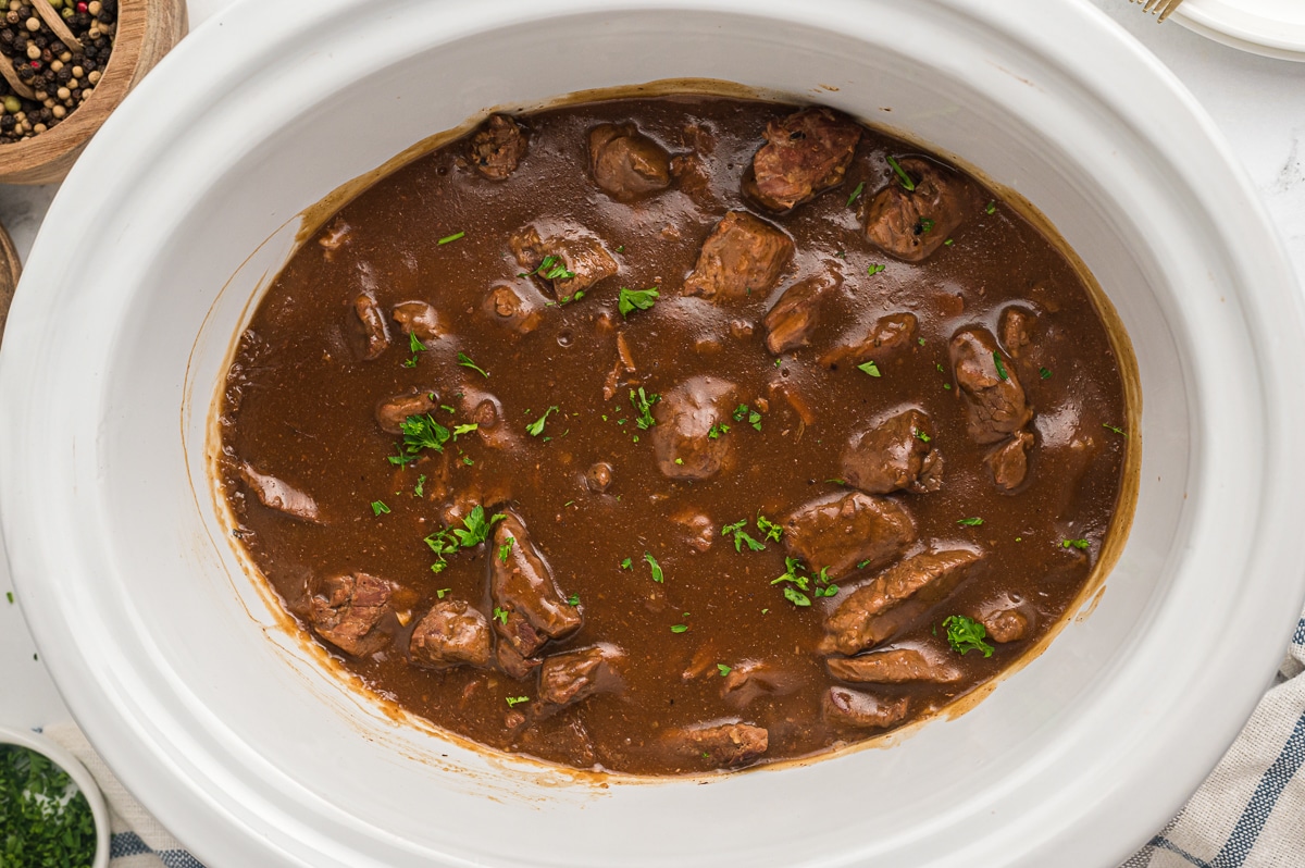 overhead shot of beef tips in slow cooker.