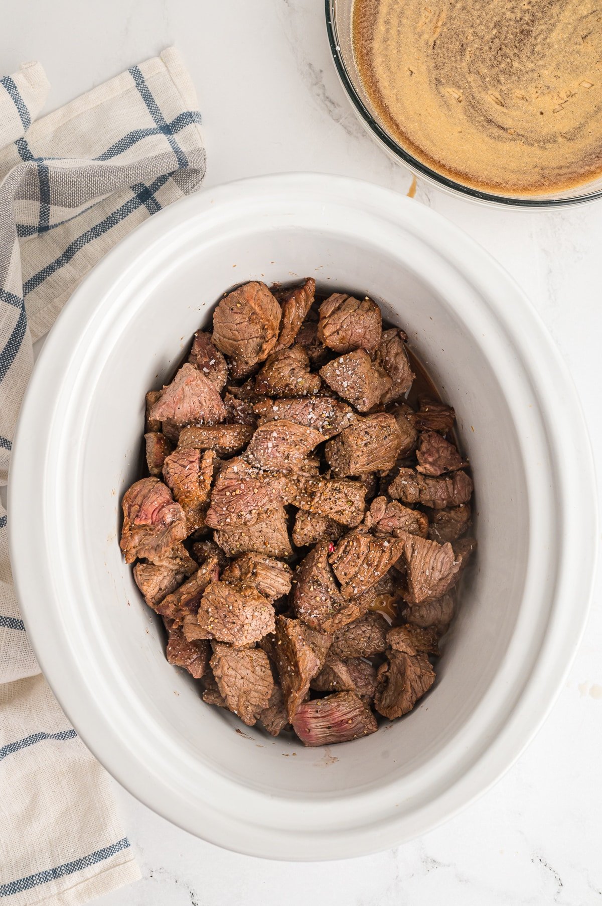 browned beef tips in a slow cooker.