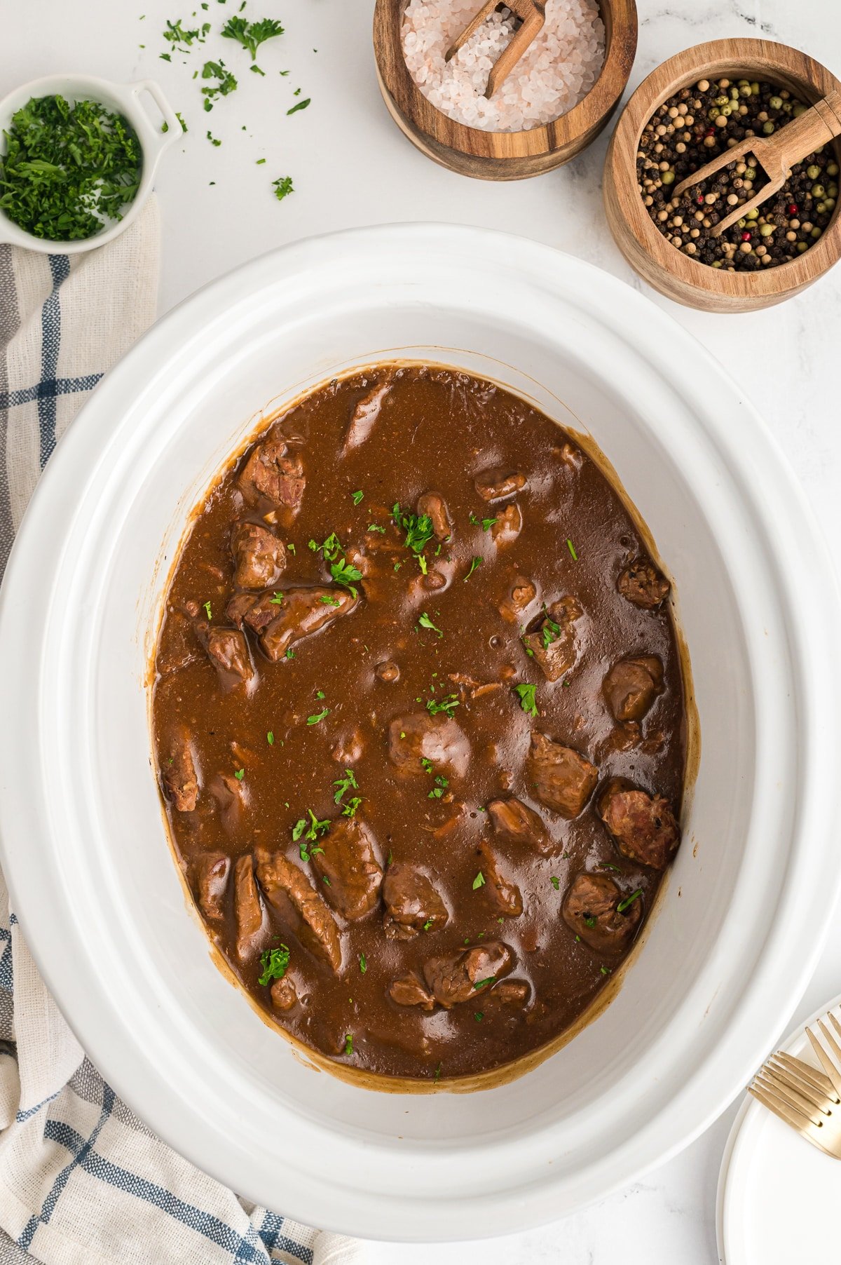 Done cooking beef tips and gravy in a slow cooker.
