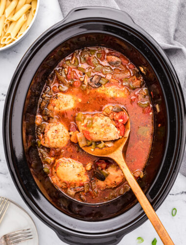 chicken cacciatore on a spoon in the crockpot.