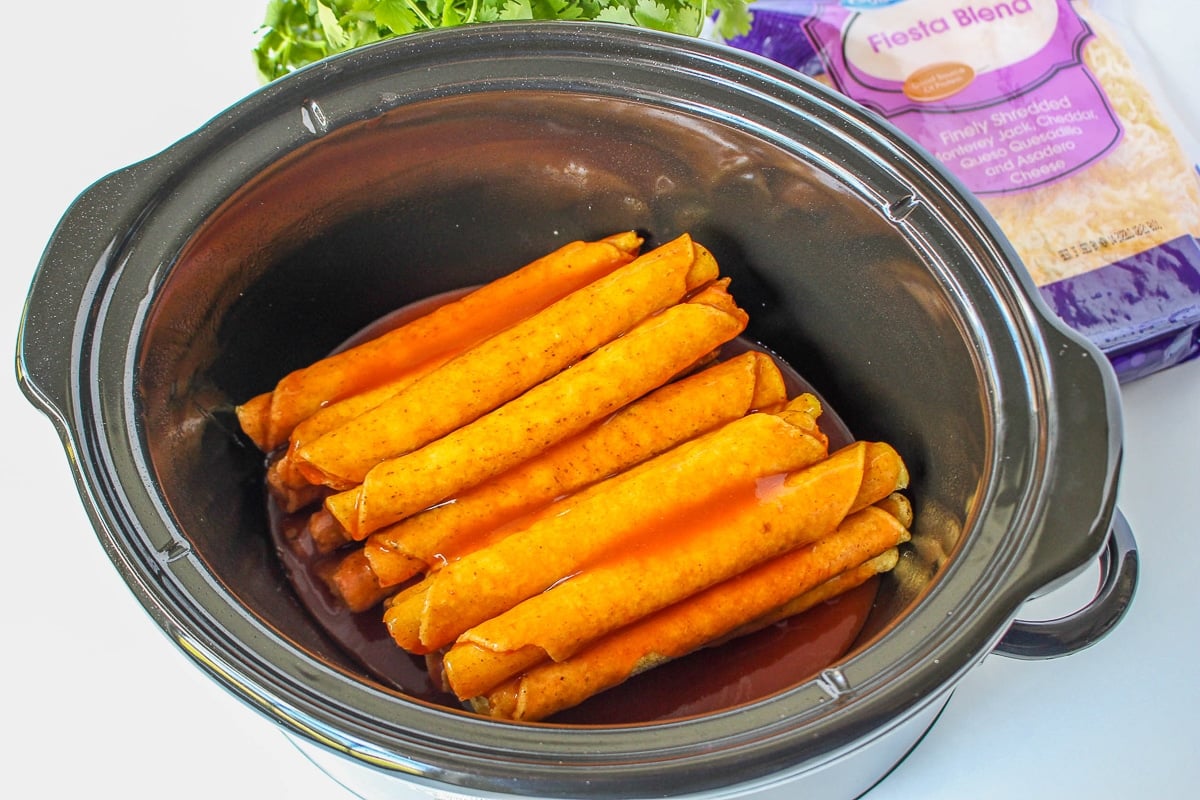 enchilada sauce over frozen taquitos in a slow cooker.