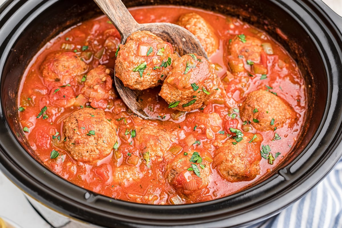 side view of turkey meatballs in crockpot.