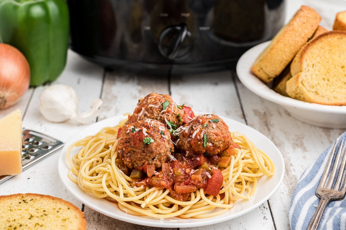 side view of turkey meatballs in front of slow cooker.