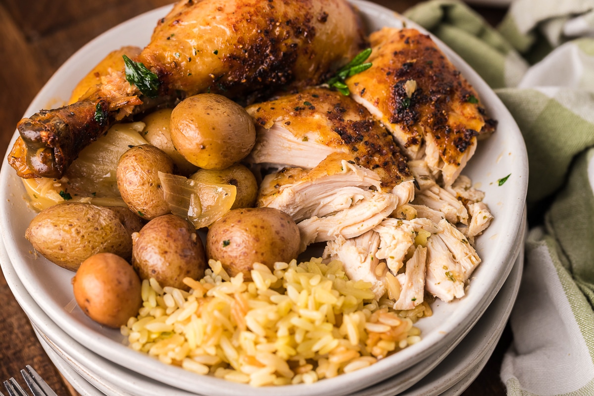 plate of rice, potatoes and chicken.