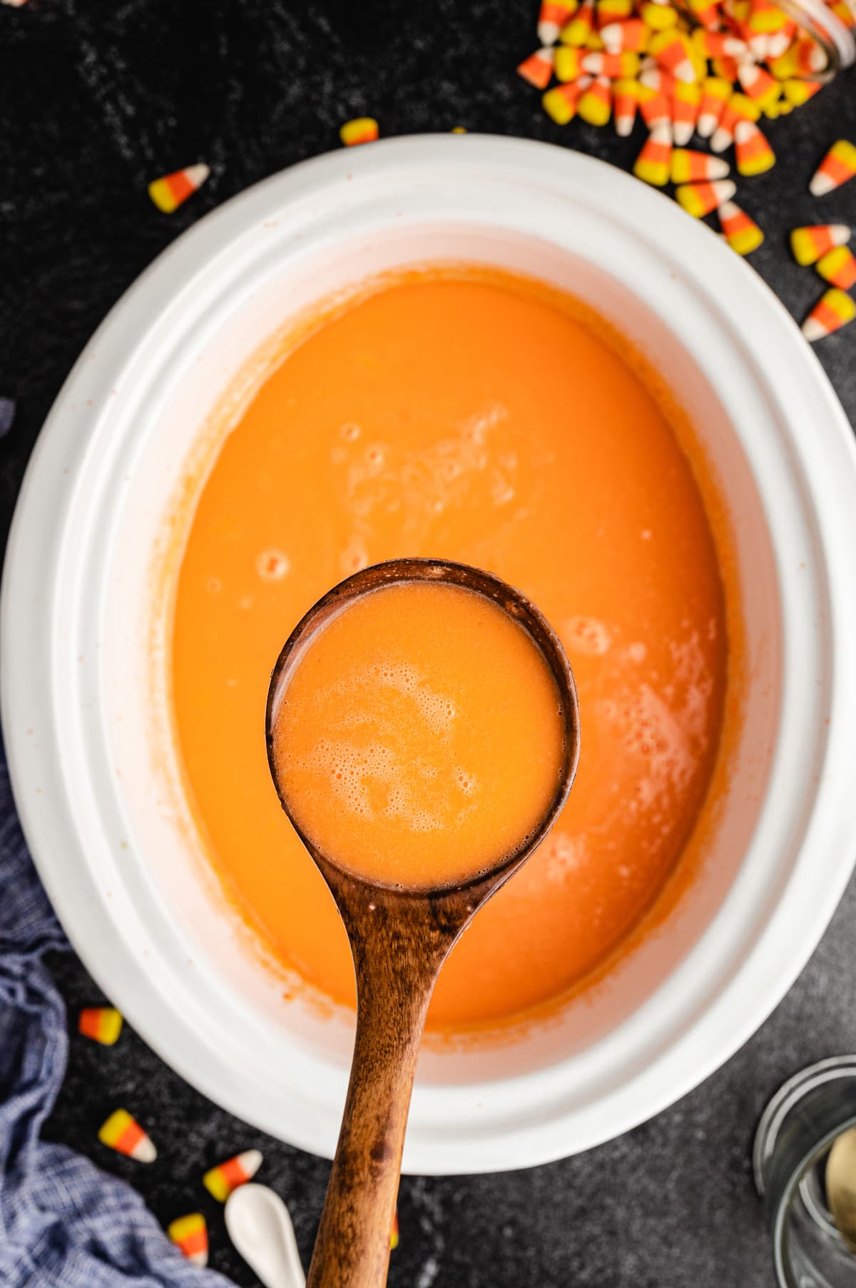 Candy hot chocolate on a wooden spoon.