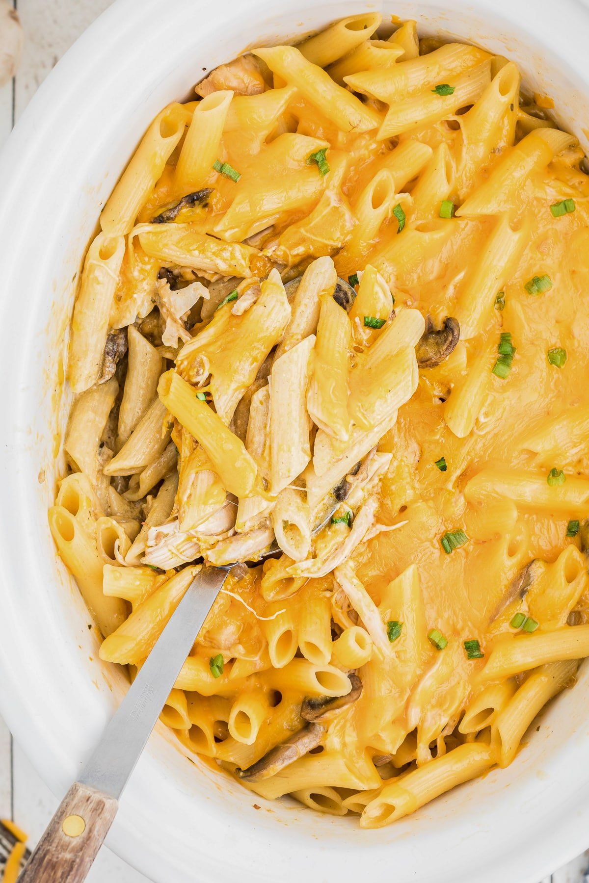 Close up of cheesy chicken penne in slow cooker.