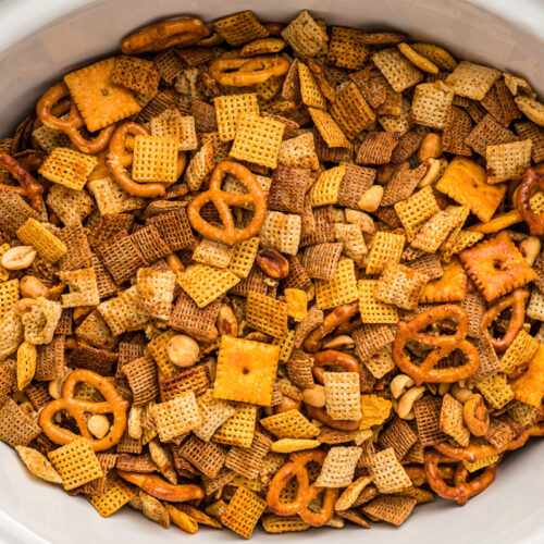 Overhead shot of chex mix in a slow cooker.