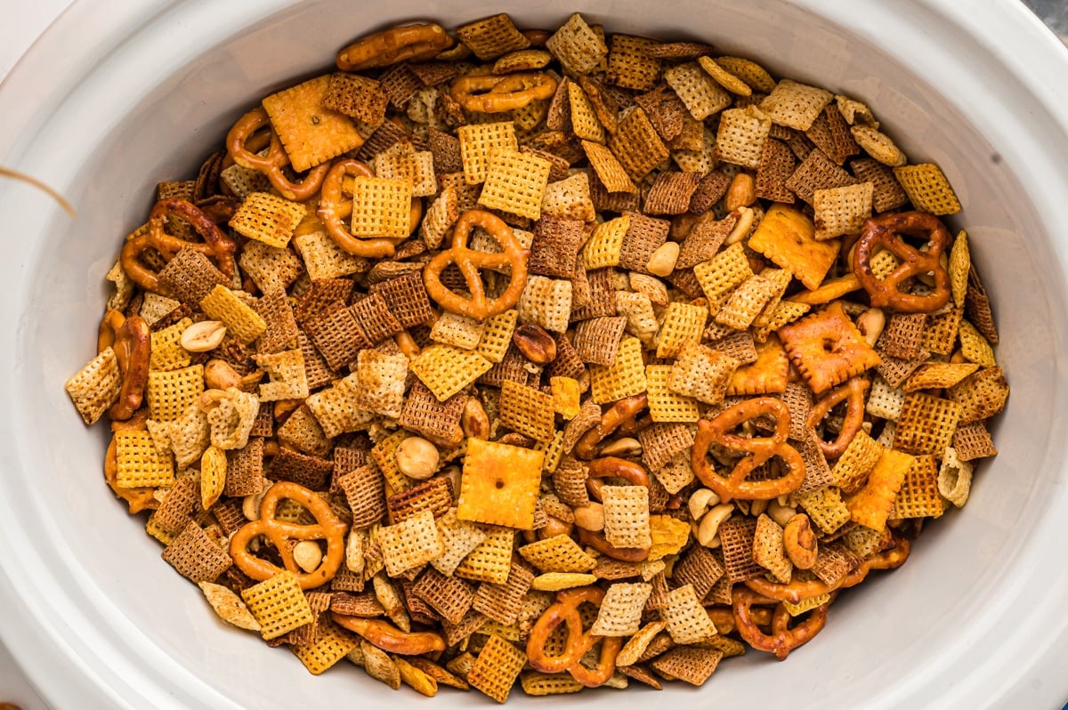 Overhead shot of chex mix in a slow cooker.