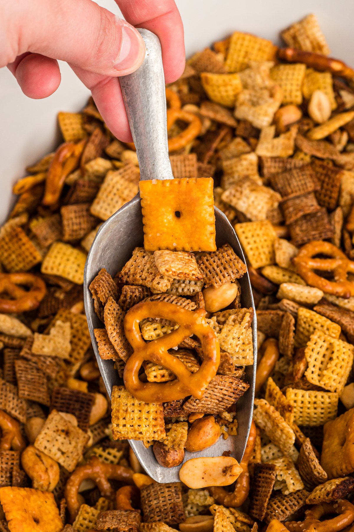 close up of chex mix on a scoop.