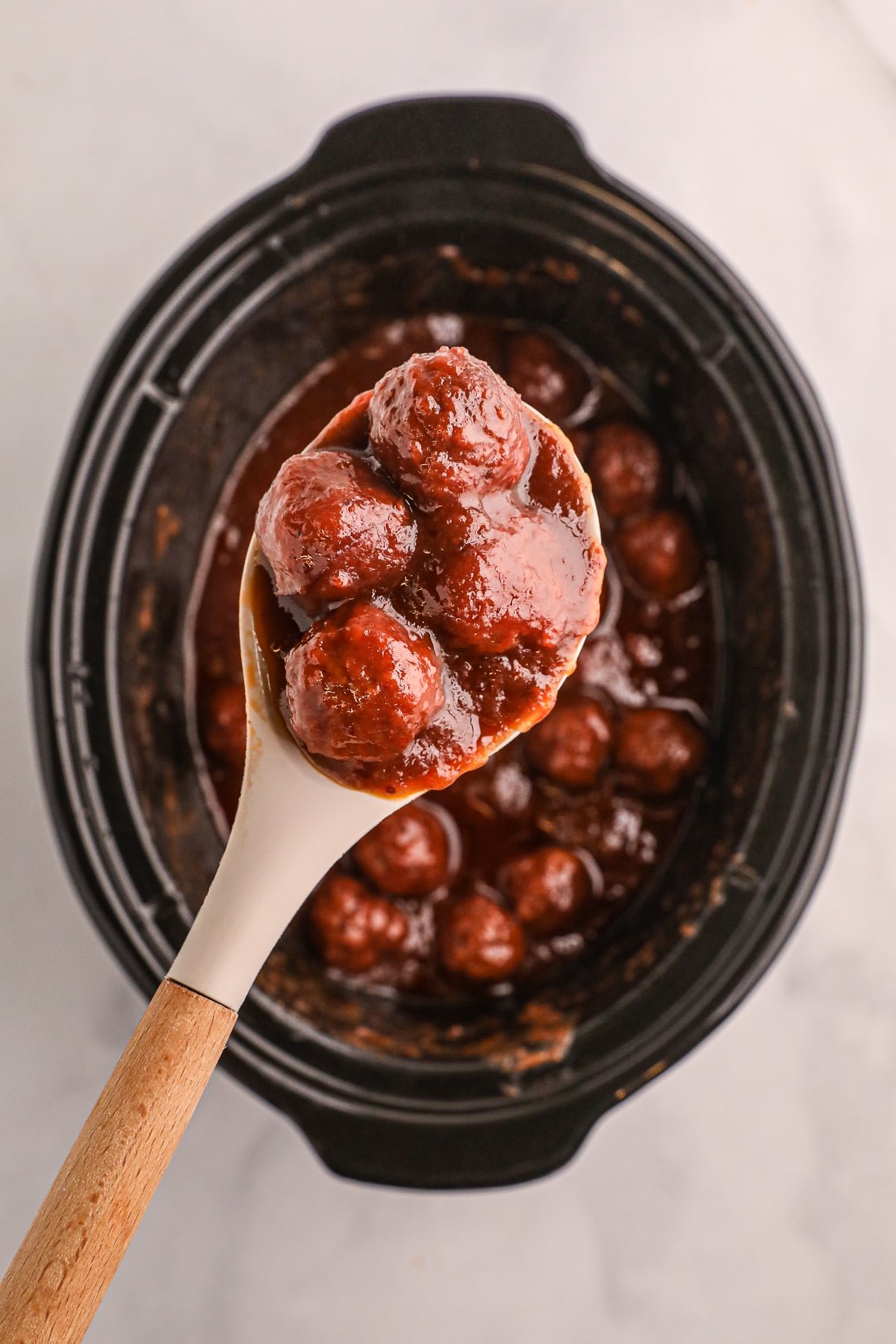 cranberry meatballs on a spoon.
