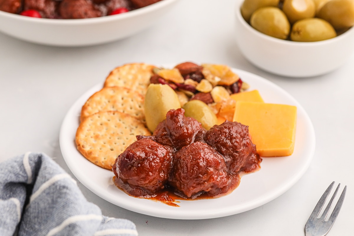 plate of appetizers with cranberry meatballs.