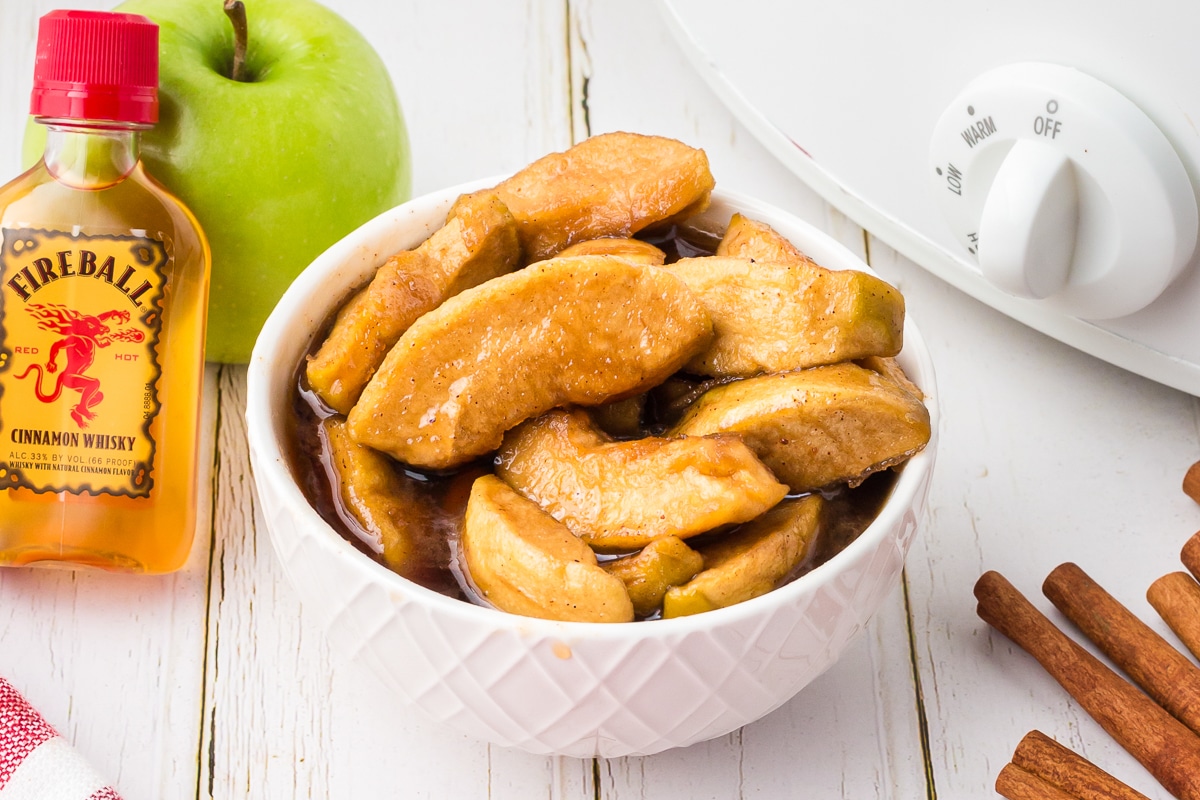 Fireball caramel apples in bowl.