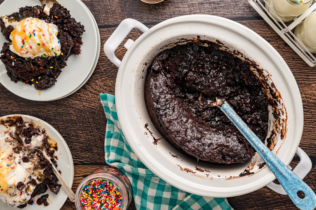 overhead shot of hot fudge cake in slow cooker and some on a plate.