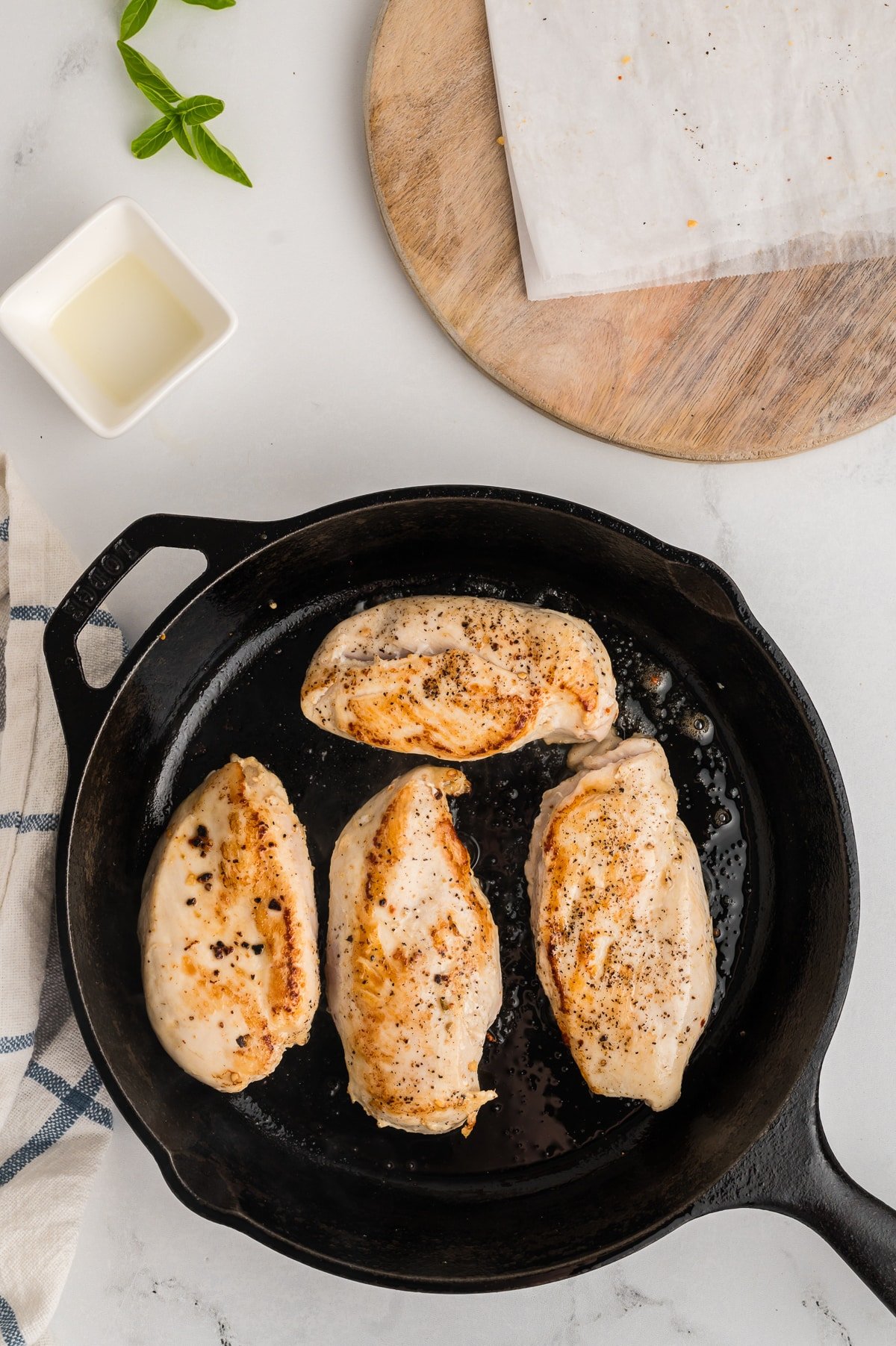 chicken nreast being browned in a skillet.
