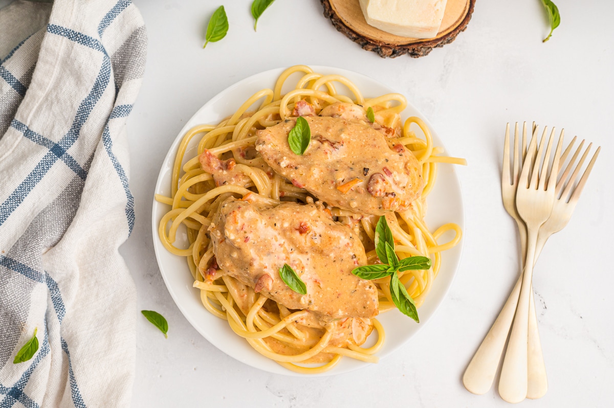 Plate of 2 marry me chicken on spaghetti.