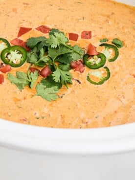 Side view of smoked queso in a crockpot.